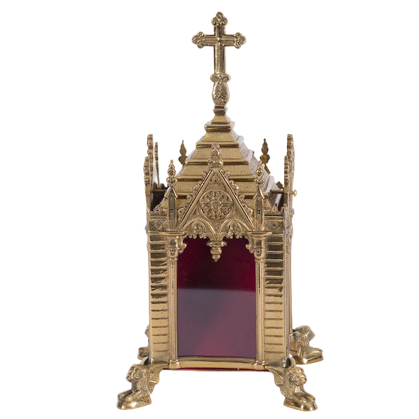 A traditional Gothic style brass relic shrine with a polished finish, cross on top. Clear glass on all four sides. Removable top to display your relics.