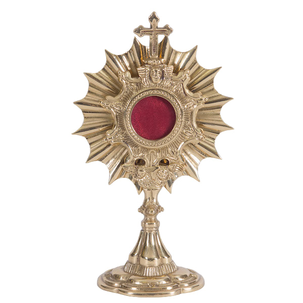 A polished brass and lacquered small 'Ray of Light' reliquary with a red viewing window and a cross on top.
Back door is removable