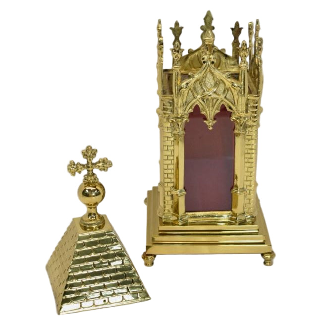 A polished brass relic shrine with glass on all four sides. Shown with the top removed.