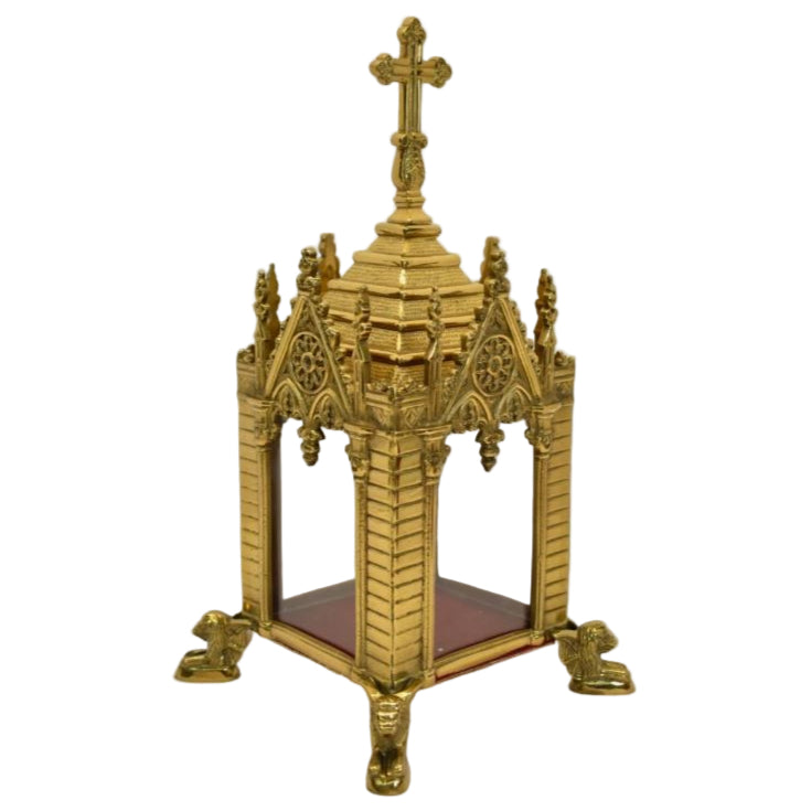 A traditional Gothic style brass relic shrine with a polished finish, cross on top. Clear glass on all four sides. Removable top to display your relics.