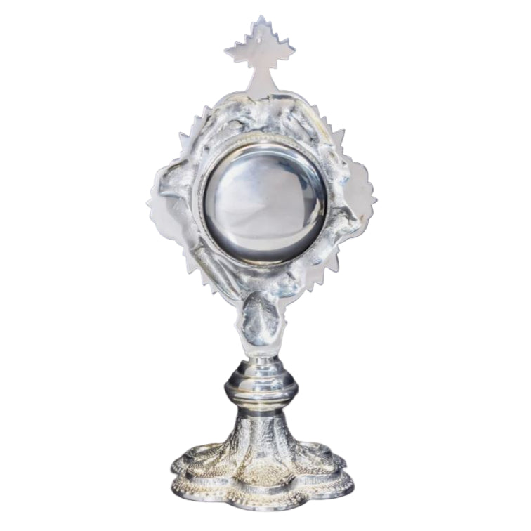 Silver plated French style reliquary with a round relic compartment and a glass front. Back view