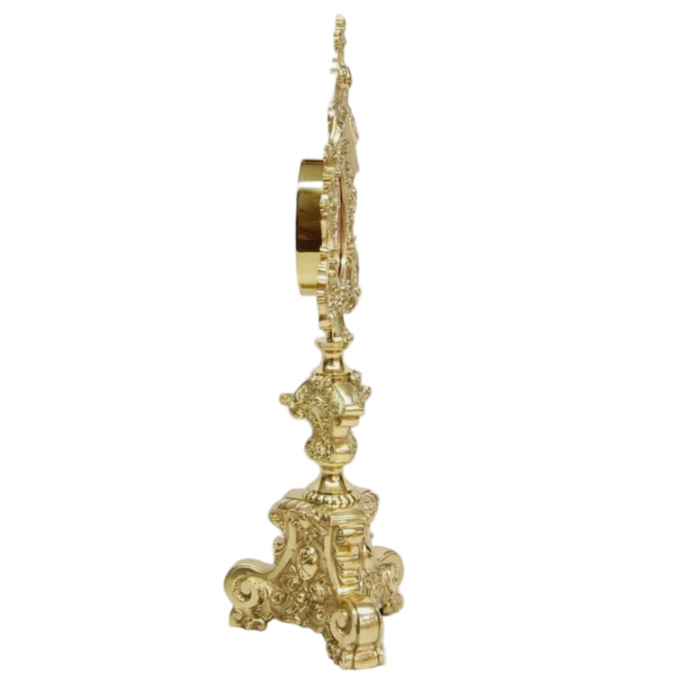 Large Ornate polished brass and lacquered reliquary. 2 Angels perched on top holding the cross. Baroque style base. Glass on front with an oval shaped relic compartment. SIDE VIEW