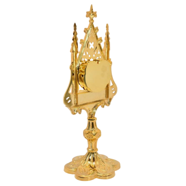 Large gold plated ornate reliquary with a heart shaped glass opening on the front and removable back door to hours your relic. All gold plated.