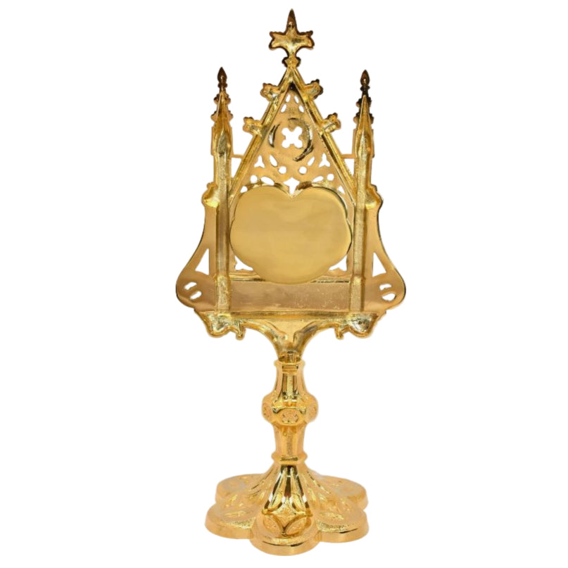 Large gold plated ornate reliquary with a heart shaped glass opening on the front and removable back door to hours your relic. All gold plated.