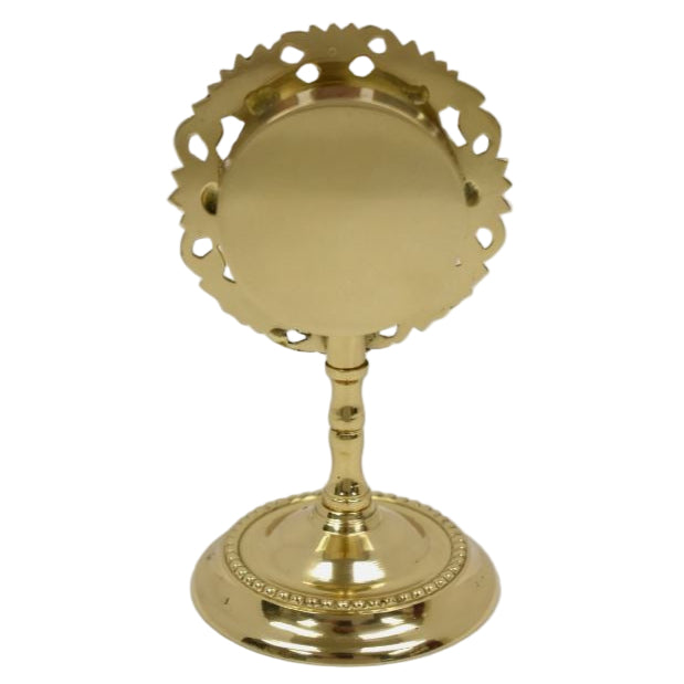 Small brass reliquary with glass opening and removable back door.