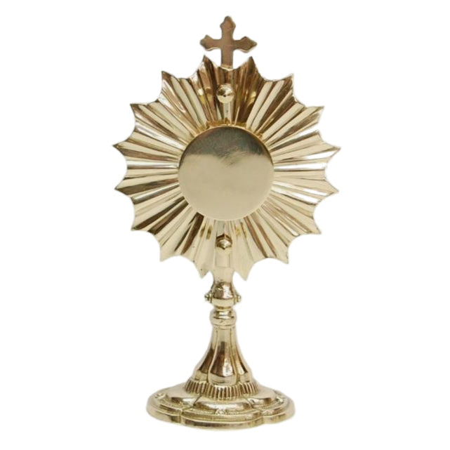 A polished brass and lacquered small 'Ray of Light' reliquary with a red viewing window and a cross on top.
Back door is removable