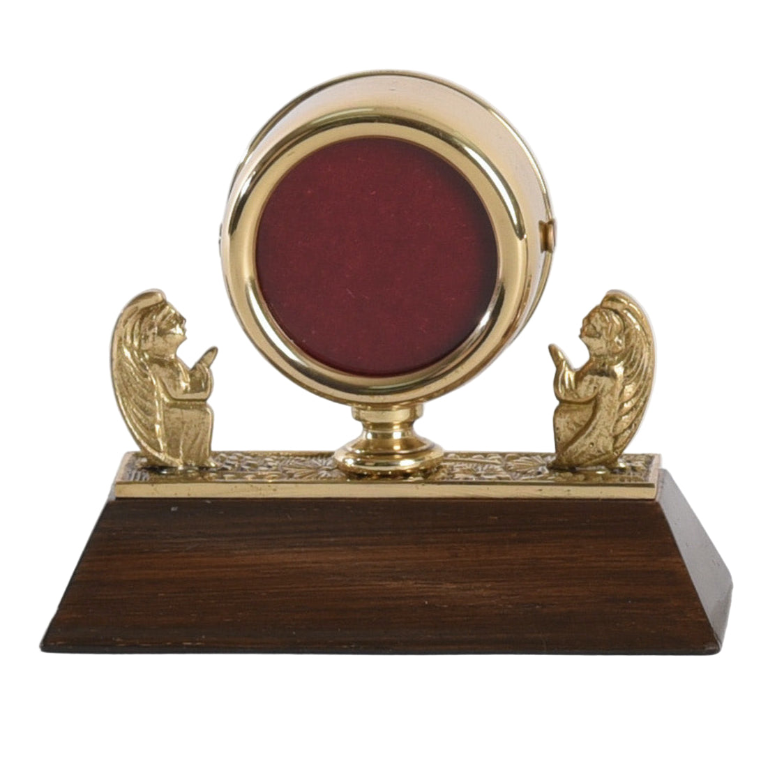 Small Brass angel reliquary on a dark wood base.