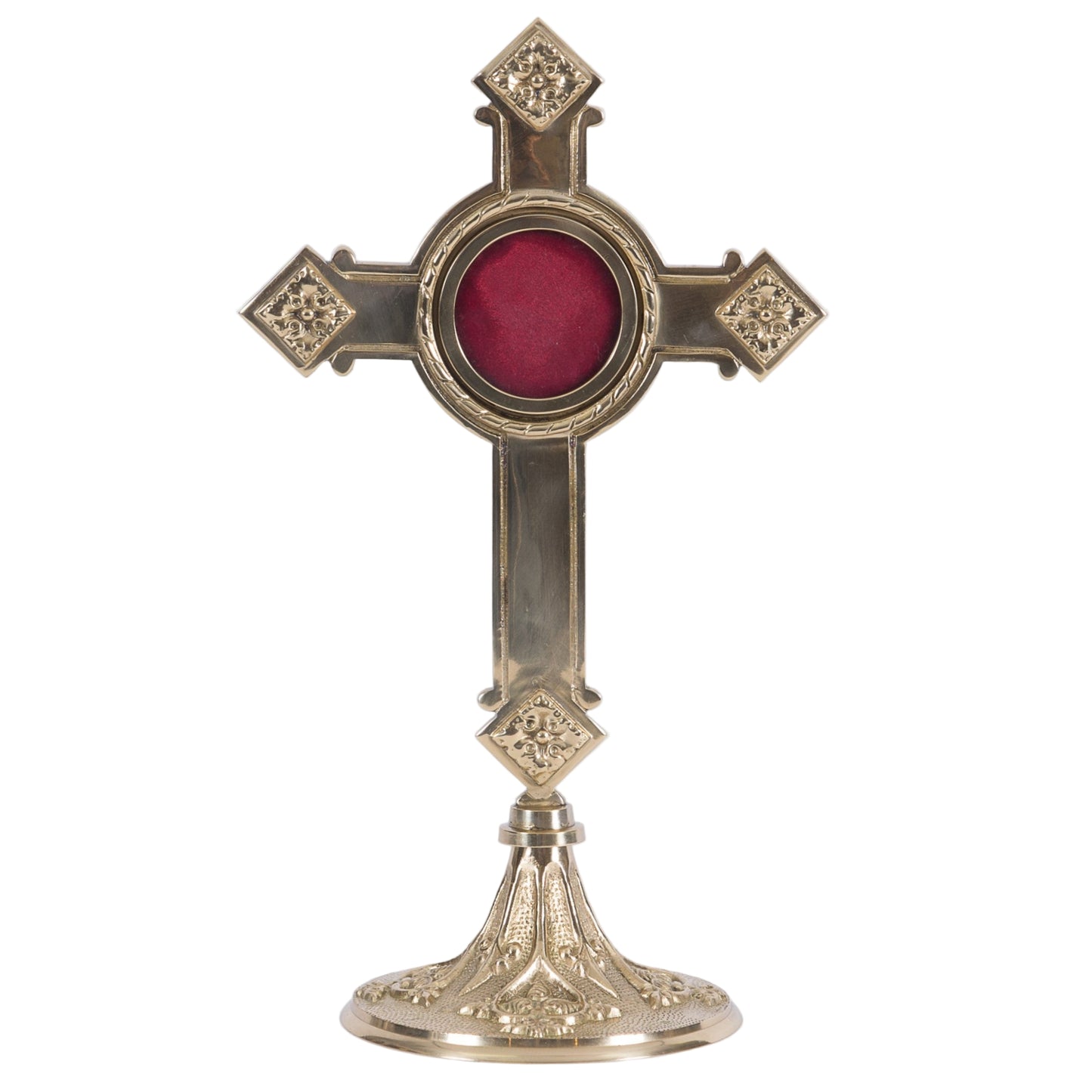 A polished brass cross-shaped reliquary with a round relic compartment and an ornate base.
Front view