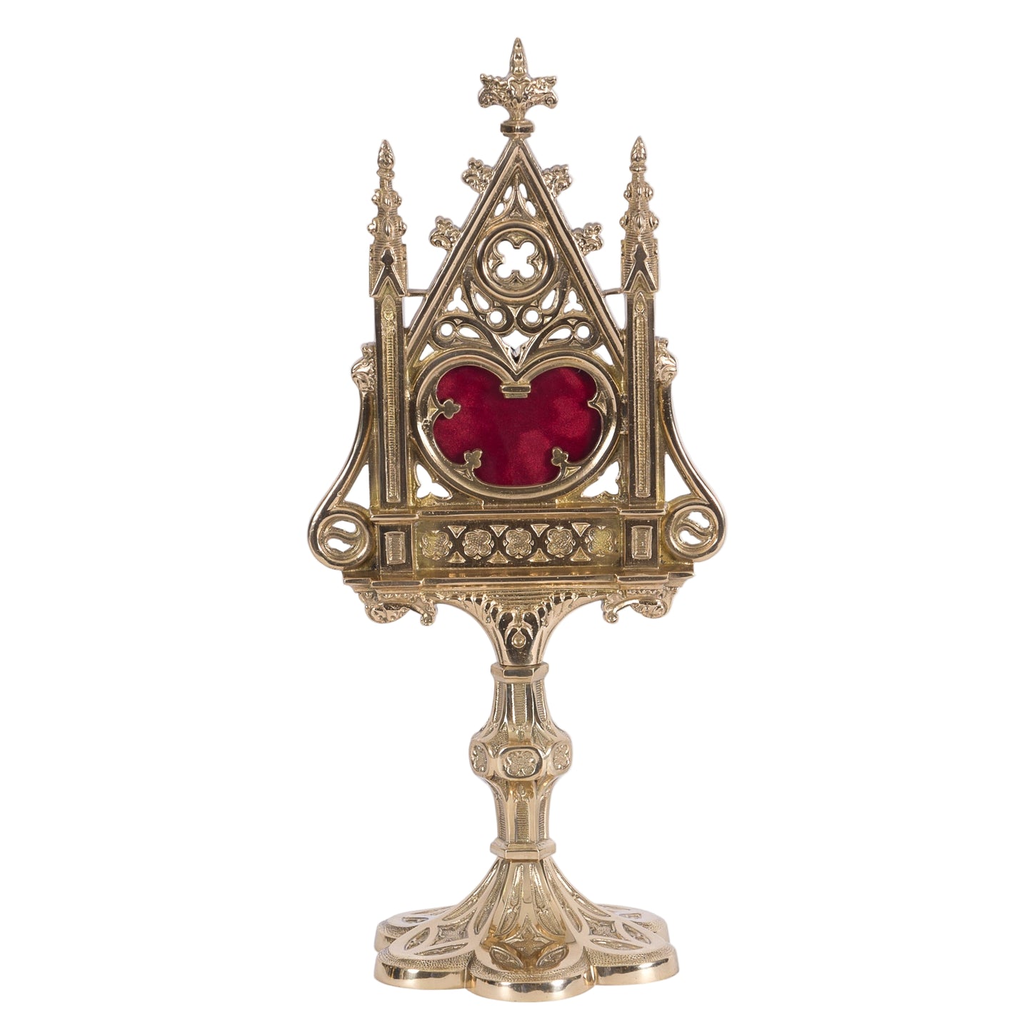 A polished brass and lacquered Gothic reliquary with a relic compartment and a heart-shaped glass opening in the center. Removable back door to house your relic.