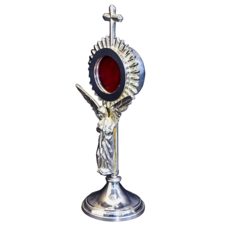 silver plated Rays reliquary with a standing angel figure as the stem. Glass on the front and removable back to display your relic. Side view.