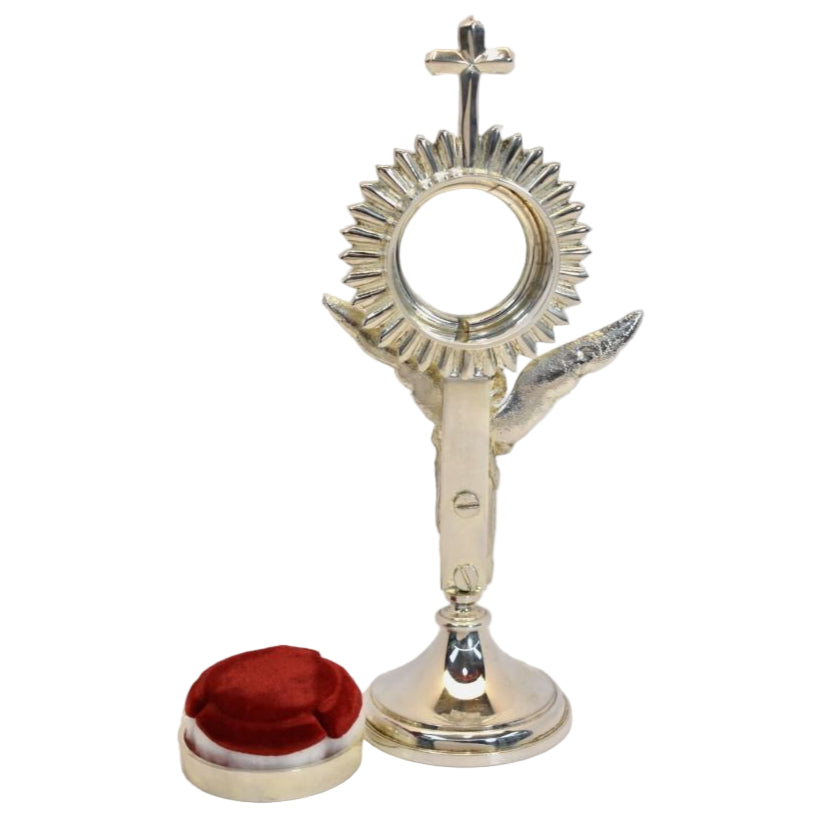 silver plated Rays reliquary with a standing angel figure as the stem. Glass on the front and removable back to display your relic. Showing back side with the door removed.