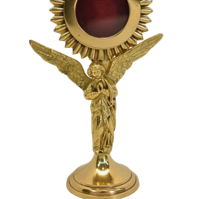 Polished brass and lacquered rays reliquary with standing Angel figure as the stem. Glass on front and removable back door.
Close up of Angel figure