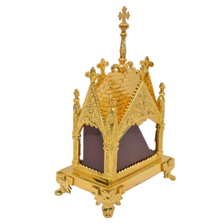 Gold plated ornate reliquary shrine with clear glass on all four sides. To display your relic.