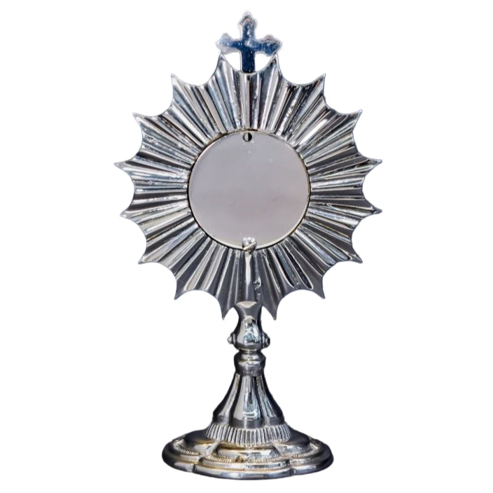 Silver plated Ray of Light reliquary with round glass opening and removable back door. Back door has 2 screws for removal