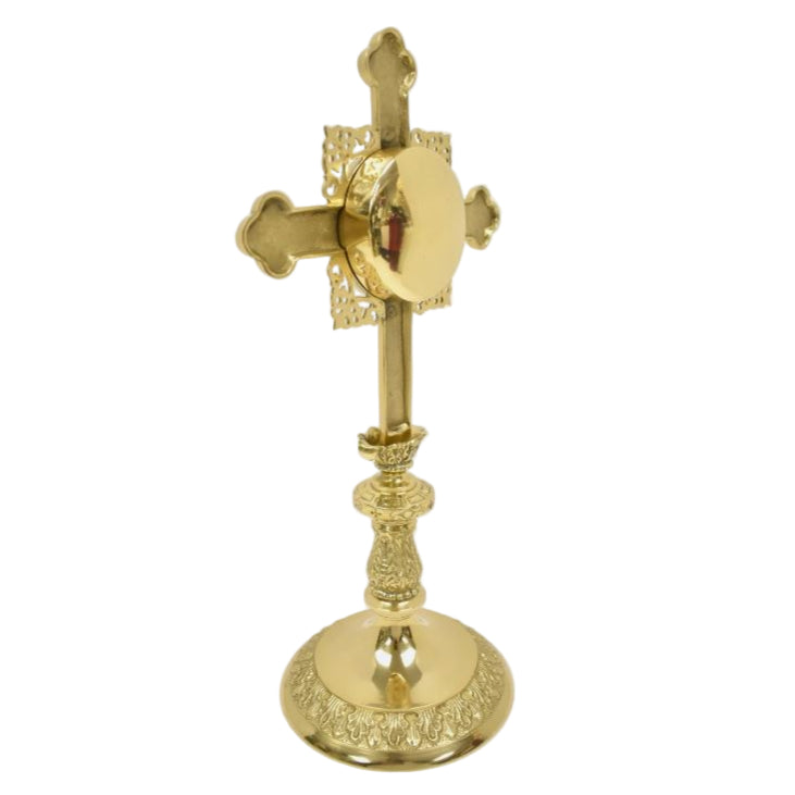 Ornate cross shaped brass reliquary with French style filigree. Floral shaped glass window on front and removable back door. 