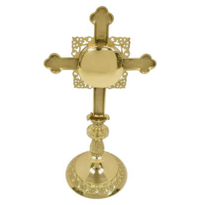 Ornate cross shaped brass reliquary with French style filigree. Floral shaped glass window on front and removable back door. 