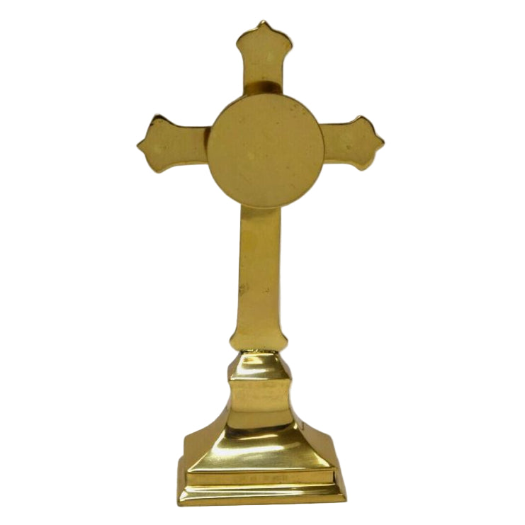 Small cross shaped reliquary with ornate filigree. Round glass display with removable back door. 