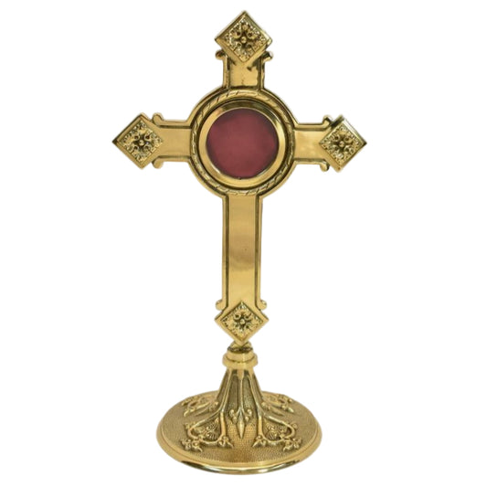 brass cross shaped reliquary with ornate base, glass on the front and removable back door.