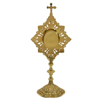 Ornate filigree reliquary in a polished brass and lacquered finish. Glass on the front and a removable door to house your relic. 
BACK VIEW