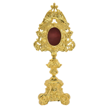 Gold plated reliquary with 2 adoring angels on the top. Glass on the front, oval relic compartment with removable back door. FRONT VIEW