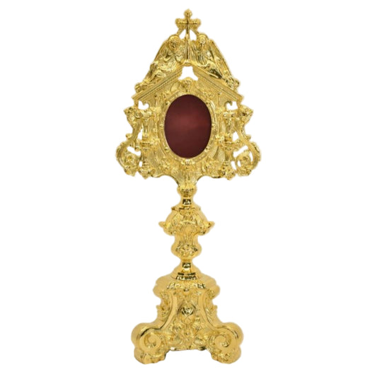 Gold plated reliquary with 2 adoring angels on the top. Glass on the front, oval relic compartment with removable back door. FRONT VIEW
