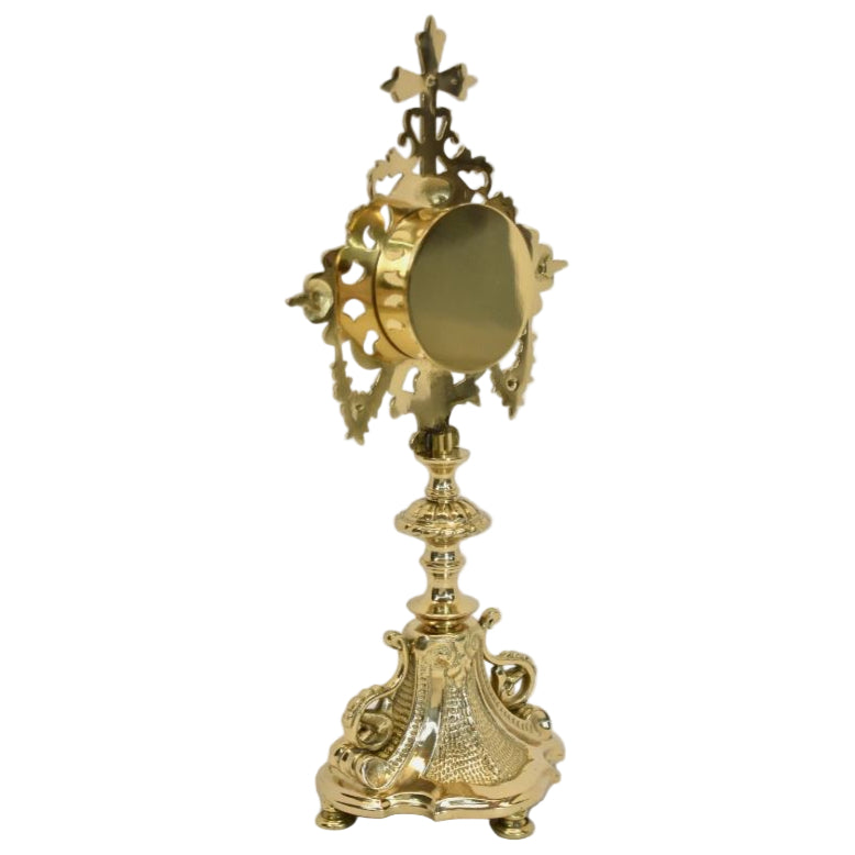 French filigree baroque style reliquary. Polished brass and lacquered. Glass on front with round removable door on the back to house your relic. 