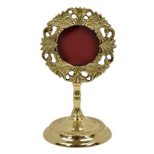 Small brass reliquary with glass opening and removable back door.