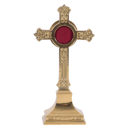 Small cross shaped reliquary with ornate filigree. Round glass display with removable back door. 