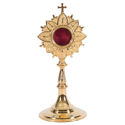Gold plated brass veneration reliquary with a round glass relic compartment at the top. Handle on the back for easy veneration use. All gold plated over brass. 
FRONT VIEW