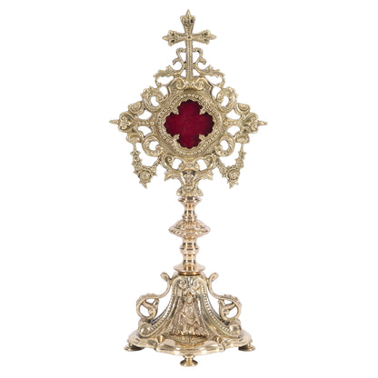 French filigree baroque style reliquary. Polished brass and lacquered. Glass on front with round removable door on the back to house your relic. 